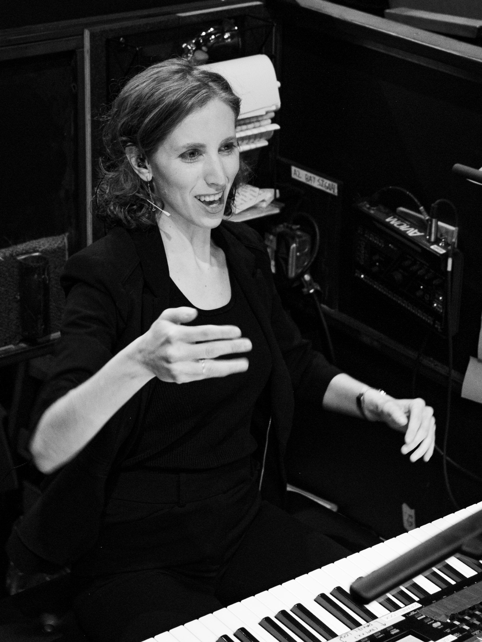 Andrea Grody, music director, conducting a musical theater production from the keyboard.